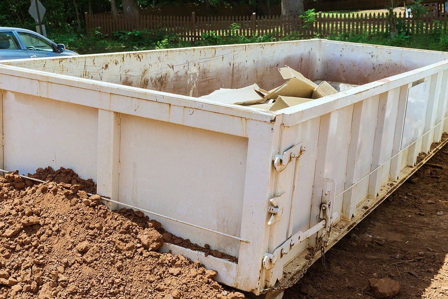 As part of the construction site waste removal process in White Plains, NY, metal containers are used to recycle the garbage in trash dumpsters.